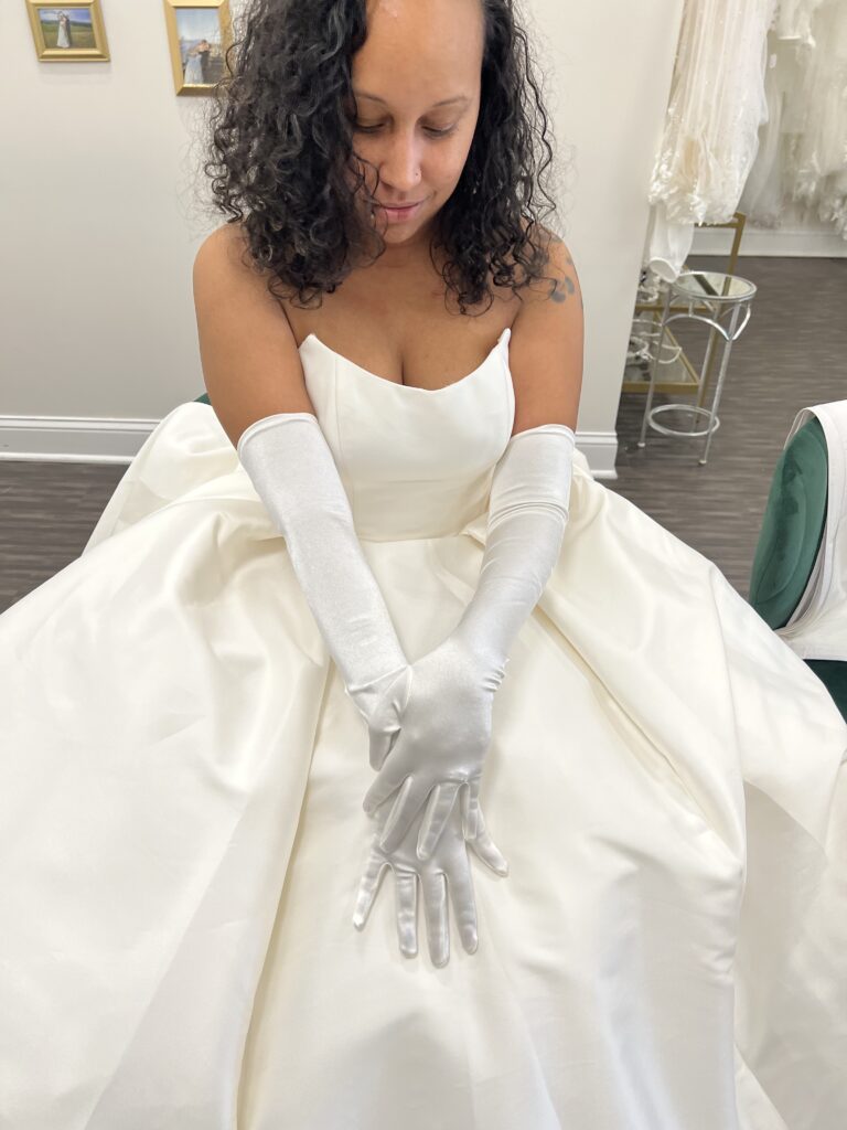 bride in a wedding dress wearing a pair of timeless white gloves