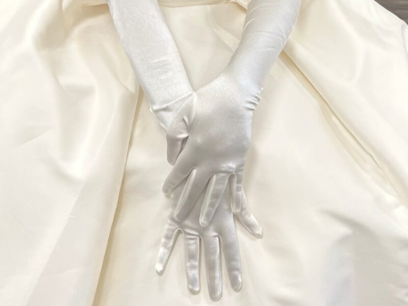 bride wearing a pair of timeless white gloves