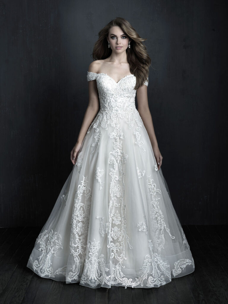 the Claudia gown by Couture Allure, a stunning lace dress with off-shoulder sleeves
