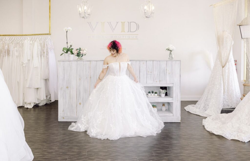 bride with pink and black hair wearing a beautiful wedding dress at Vivid Bridal Boutique